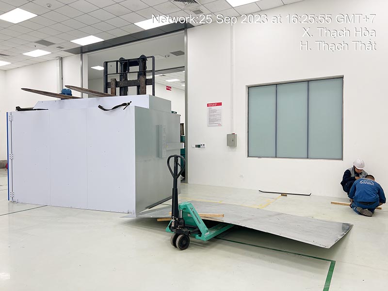 công nhân dùng xe nâng tay di chuyển tấm tôn lớn